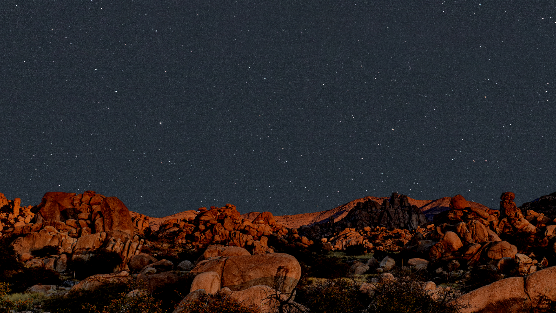 The boulders of Texas Canyon in the foreground with a starry filled sky above