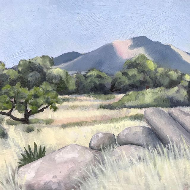 Painting by Maria Arvayo showing the Amerind Campus, with desert grass, boulders and Dragoon Mountains