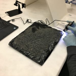 obsidian tablet being examined