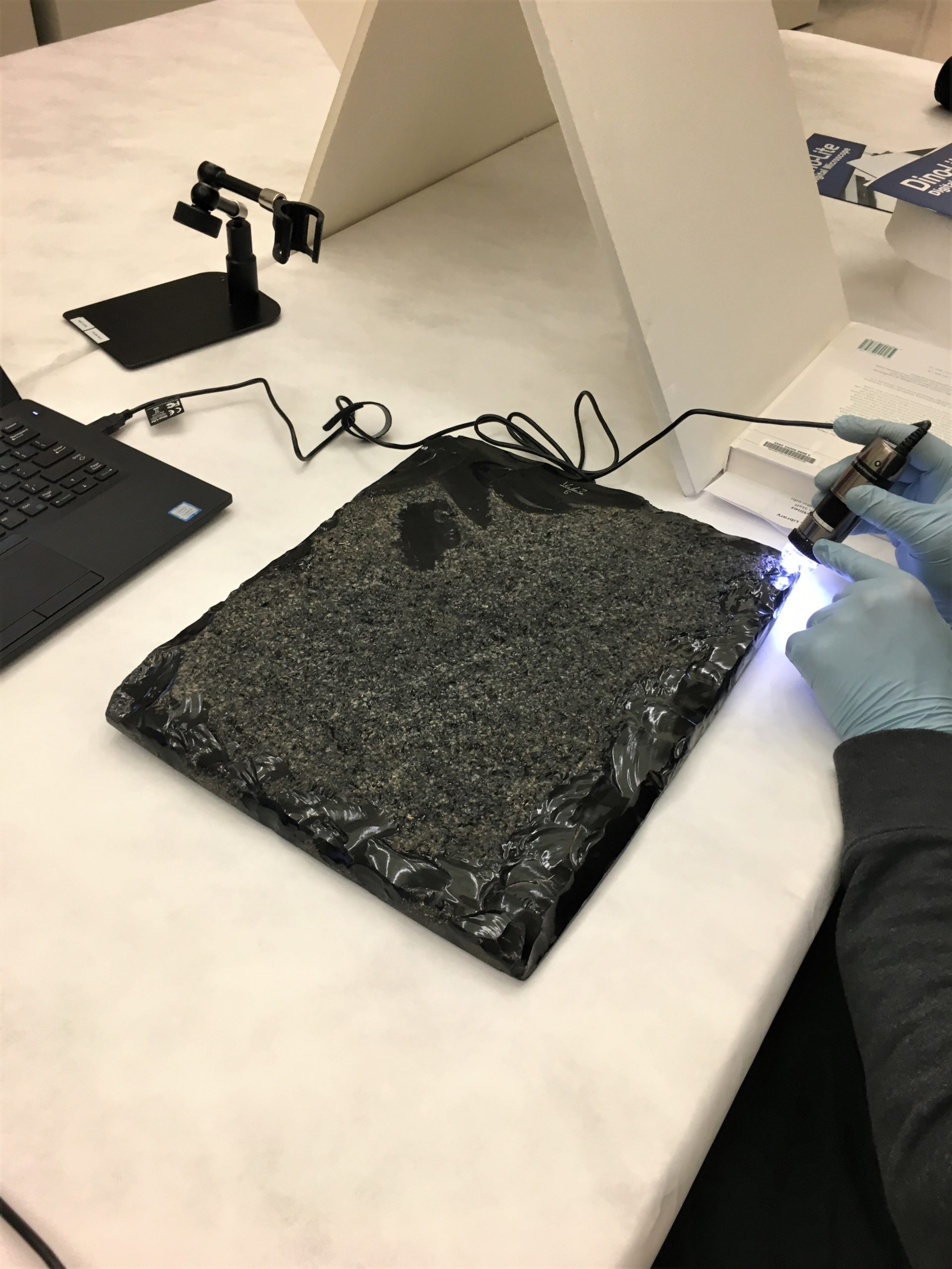 obsidian tablet being examined