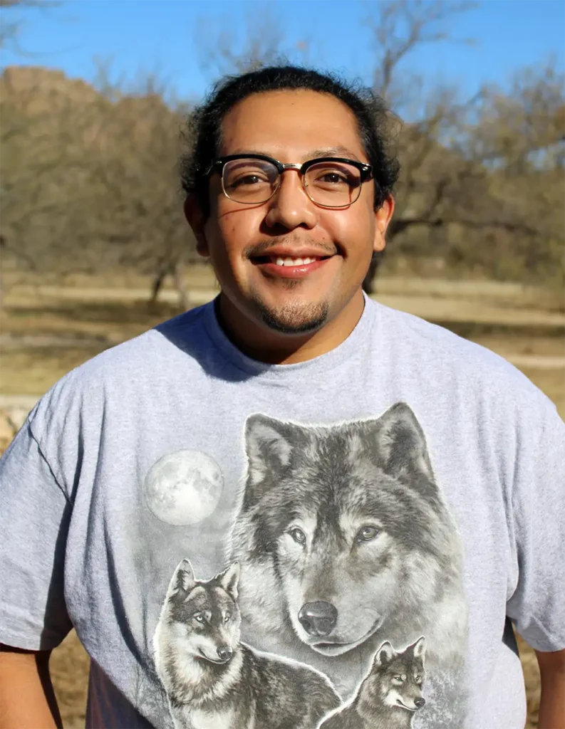 Tohono O'odham artist Derrick Gonzalez. A young man with long black hair and glasses.